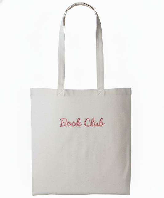 White tote bag with 'Book Club' text in pink on a white background